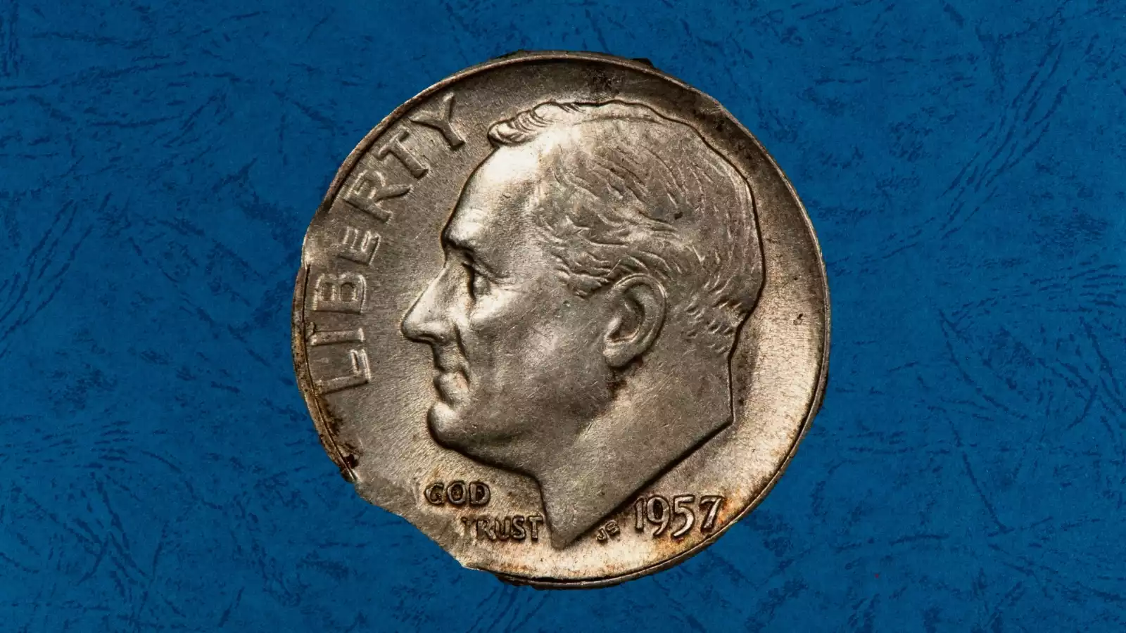 1957 Roosevelt dime clipped planchet error showing curved bite missing from coin edge